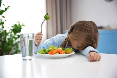 girl refusing to eat vegetables